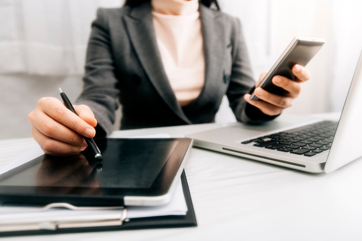 businesswoman using laptop tablet and phone