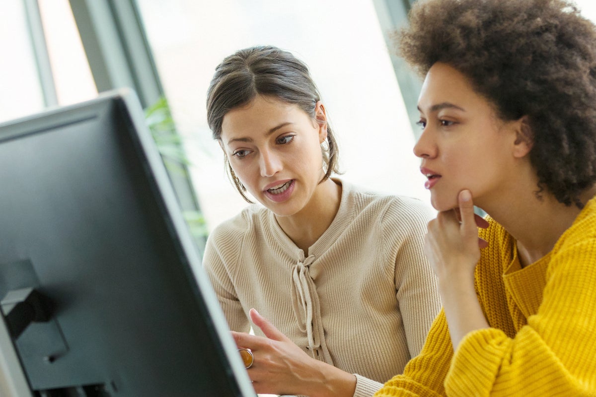 two women at computer collaboration collaborate job training intern apprentice mentor by gilaxia ge